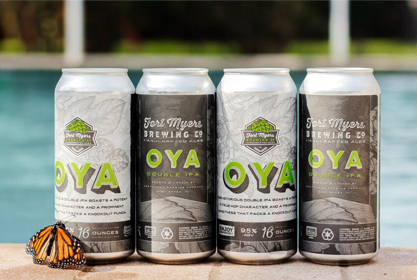 Four cans of oya sitting next to a pool.